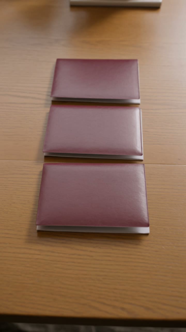 Passports and citizenship documents on a wooden kitchen table